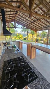 a kitchen with a black stove top oven in a kitchen at Pousada do Barão in Lindóia