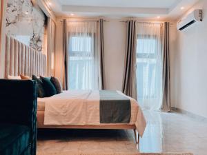 a bedroom with a bed and a large window at Alpine Grande in Kathmandu
