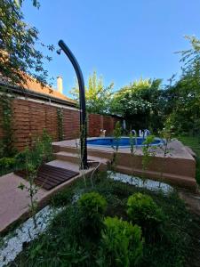 a swimming pool in a yard with a garden sidx sidx sidx at Guest Zimmer Nora in Zamárdi