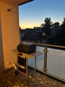 a grill sitting on a table on a balcony at Villa ENTO HotelWestEnd in Frankfurt