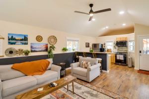 a living room with a couch and a ceiling fan at Gateway to Glacier! 2-Cabin Compound for Groups in Columbia Falls