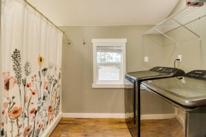 a bathroom with a sink and a window at Gateway to Glacier! 2-Cabin Compound for Groups in Columbia Falls +25 photos