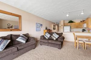 a living room with two couches and a kitchen at East Bay Condos #111 in Dillon