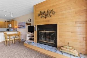 a living room with a fireplace and a table at East Bay Condos #111 in Dillon