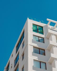a white building against a blue sky at Alpine Grande in Kathmandu