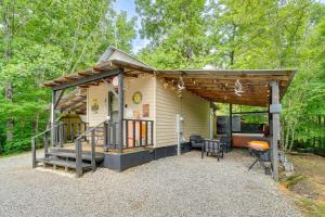 a small cabin in the woods with a patio at House & Tiny Cabin! Multi-Acre East TN Property in Englewood