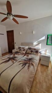 a bedroom with a bed with a ceiling fan at Lukite House in Tías +24 photos