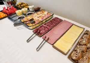 ein Buffet mit Käse, Wurstwaren und Brot in der Unterkunft Pousada Parque in Mostardas