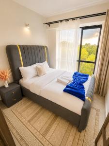 a bed in a room with a large window at Ongata Rongai Pool Studio Near Nairobi National Park and giraffe center in Ongata Rongai  +17 photos