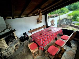 a room with a table and chairs and a fireplace at Vintage House in Elena