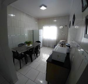 a small kitchen with a table and a dining room at Pousada Familiar 10 in Rio do Sul