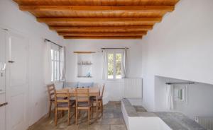 a dining room with a wooden table and chairs at Oneiro Serifos House in Serifos Chora