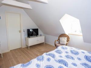 a bedroom with a bed and a tv and a window at 5 person holiday home in Øster Assels-By Traum in Øster Assels