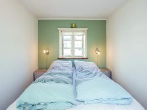 a bed in a room with a window at 5 person holiday home in Øster Assels-By Traum in Øster Assels