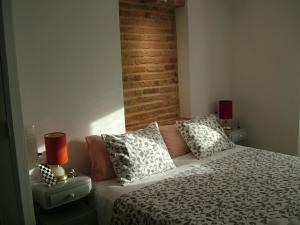 a bedroom with a bed with pillows and two lamps at Casa dos Pedro´s in Vila Nova +28 photos