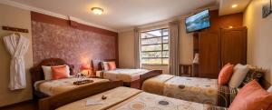 En eller flere senge i et værelse på Hotel Pegasus