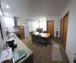 a kitchen and dining room with a table and chairs at RECANTO da VONINHA in Castelo de Paiva