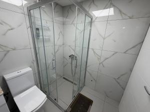 a bathroom with a shower and a toilet at Central Apartments Kukoski Near Lake & Old Town in Ohrid +11 photos