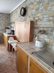 a kitchen with a counter top and a stone wall at San Isidro in Villarcayo