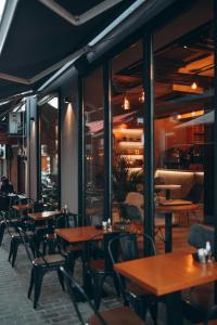an empty restaurant with wooden tables and chairs at Alpine Grande in Kathmandu