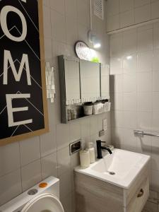 a white bathroom with a sink and a toilet at Departamento chic centro 2 habitaciones in Mendoza +46 photos