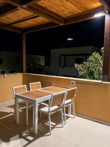 a wooden table and chairs on a patio at Villa Favignana in Favignana