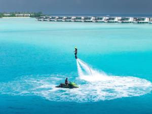 two people on a jet ski in the water at SO/ Maldives in South Male Atoll