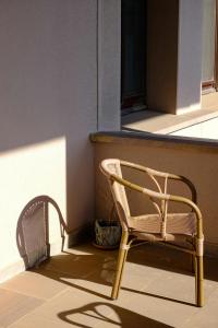 a rattan chair sitting next to a window at Alpine Grande in Kathmandu +17 photos