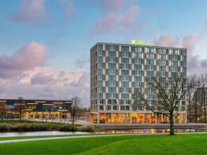 a rendering of a hotel building with a park at ibis Styles Rotterdam Ahoy in Rotterdam