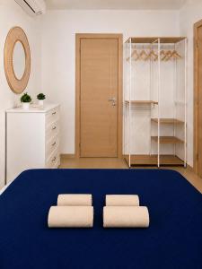 a room with a large blue bed with two pillows at Villa Favignana in Favignana