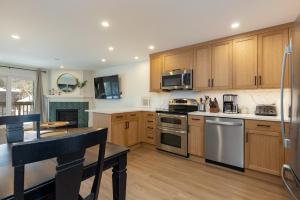 a kitchen with wooden cabinets and stainless steel appliances at Tenmile Creek #215 : 2 in Frisco