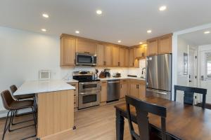 a kitchen with wooden cabinets and stainless steel appliances at Tenmile Creek #215 : 2 in Frisco