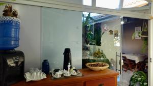 a room with a fish tank and a table with china at Pousada Canto das Samambaias in Capitólio +19 photos