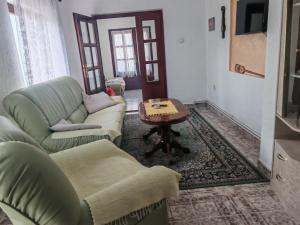 a living room with two couches and a table at Apartman Darija in Vrnjci