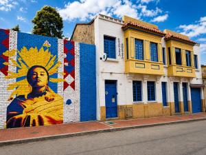 a building with a mural on the side of it at Granada Hostel in Bogotá