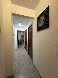 a clock on a wall next to a hallway at TAJ house center Altea #C in Altea