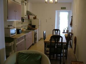 a kitchen with a table and chairs and a dining room at Casa dos Pedro´s in Vila Nova