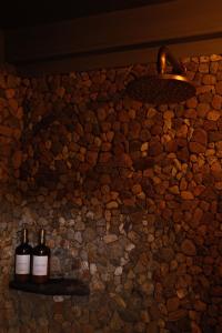 two bottles of wine on a stone wall at Casa Chuparrosas in San Mateo Río Hondo