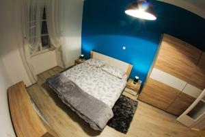 a bedroom with a bed with a blue wall at Apartment Jasmin in Rijeka