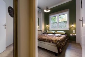 a bedroom with two cats laying on a bed at Vintage Apartment in the Heart of Plaka in Athens