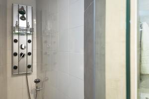 a bathroom with a shower with a glass door at Vintage Apartment in the Heart of Plaka in Athens +13 photos