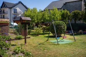 a swing set in a yard in a backyard at Pokój - Nad Zatoką in Jastarnia