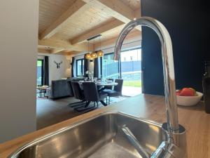 a kitchen with a sink and a dining room at Obermöschach 1A in Lake Pressegg +36 photos