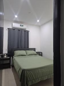 a bedroom with a bed and a air conditioner at Island Ease Villa in Willemstad