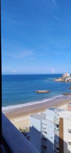 a view of a beach and the ocean from a building at Toulon in Guarapari