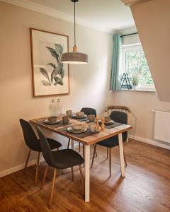 a dining room with a table and chairs at Green Lake House in Petershagen