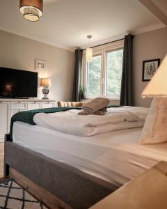 a bedroom with two large beds and a television at Green Lake House in Petershagen