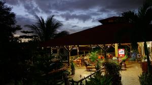 a restaurant with a patio with tables and chairs at Hotel Cerro Lodge in Tárcoles