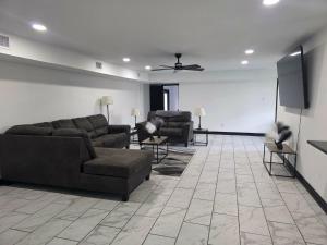 a living room with couches and a flat screen tv at Alma House in Corpus Christi