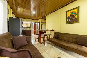 a living room with a couch and a table at Hormiga's Houses La Fortuna in Fortuna